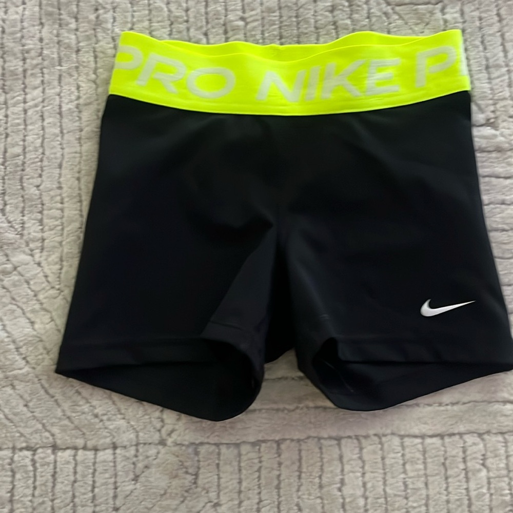 Black Nike Pros with neon green waistband